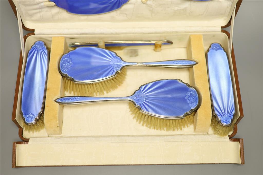 A cased George V silver and blue guilloche enamel six piece dressing set(a.f.) Mappin & Webb, Birmingham, 1929.